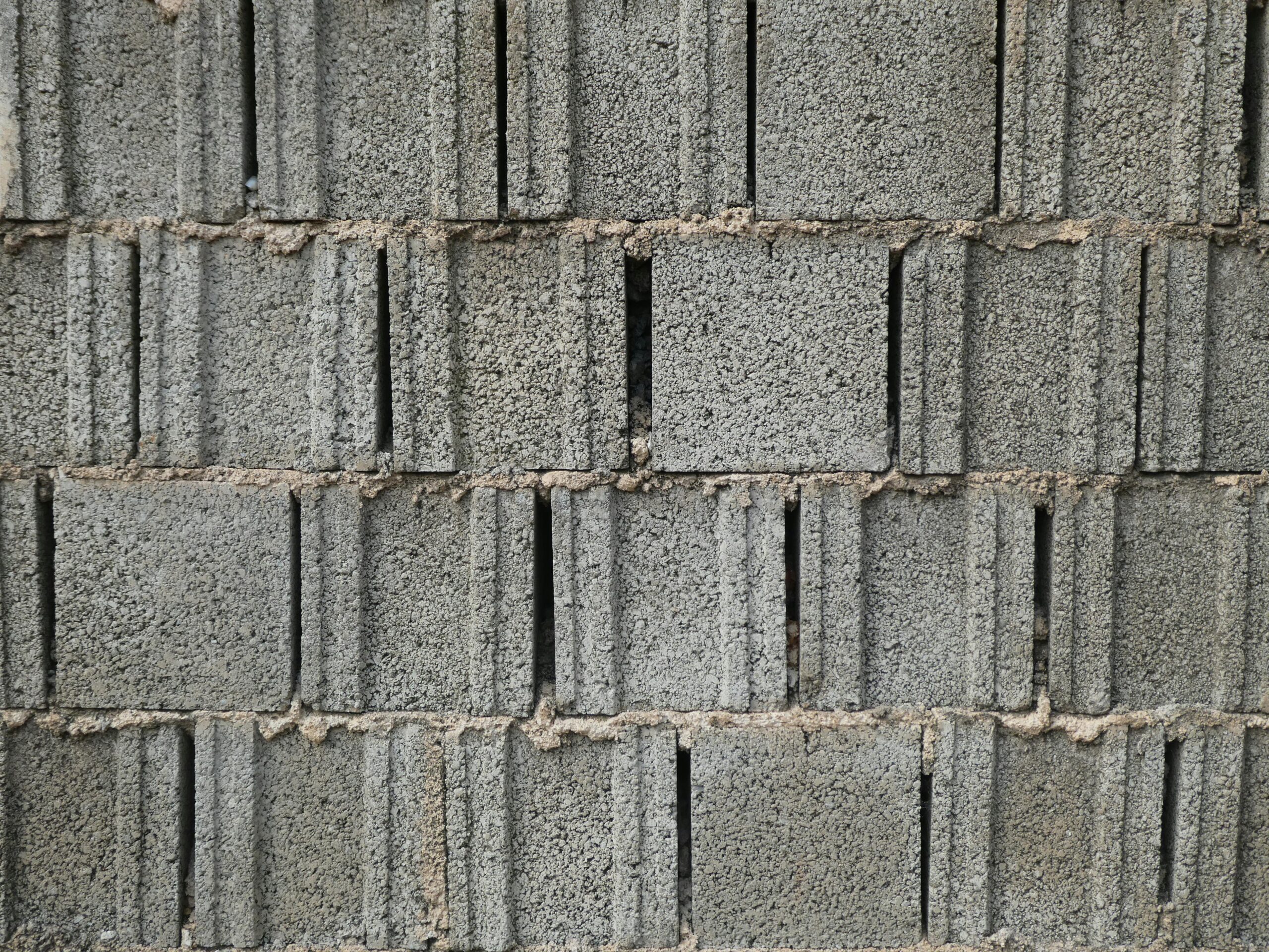 Close-up of a gray cinder block wall with a rough texture, perfect for backgrounds.