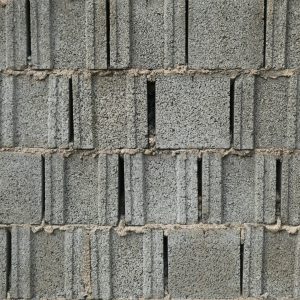 Close-up of a gray cinder block wall with a rough texture, perfect for backgrounds.